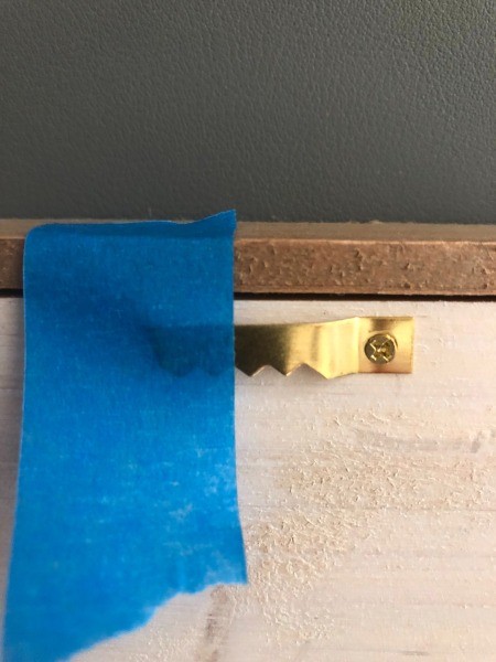 Masking tape on the picture frame hanger.