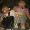 Two Cabbage Patch dolls in a bag.