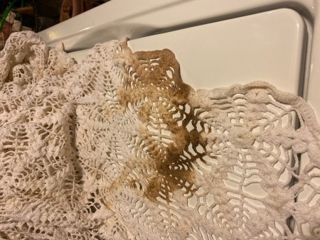 An oil stain on a crocheted tablecloth.