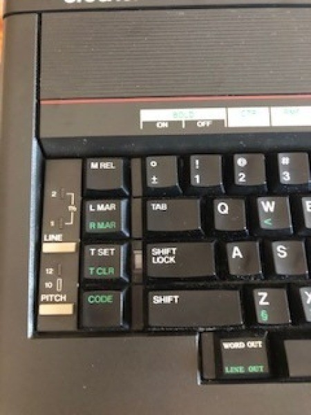 A close up of the keys on an electric typewriter.