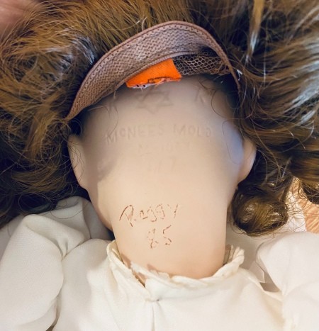 Marking on the back of a porcelain doll's neck.