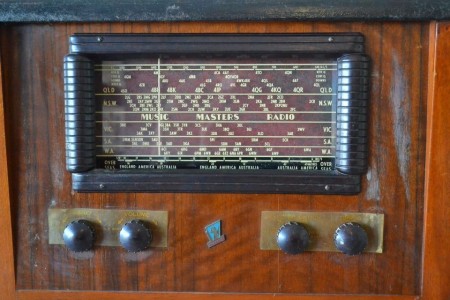 A close up of a radio turner on a stereo cabinet.