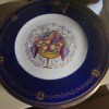 A decorative china plate with a blue rim.