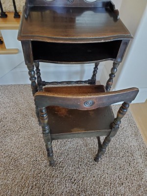 A small wooden desk with matching chair.