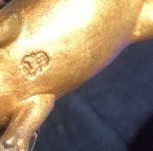 The marking on the underside of the figurine.