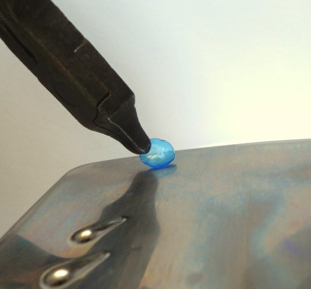 Melting the edges of the plastic circles.