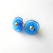 The stud earrings with plastic circles.