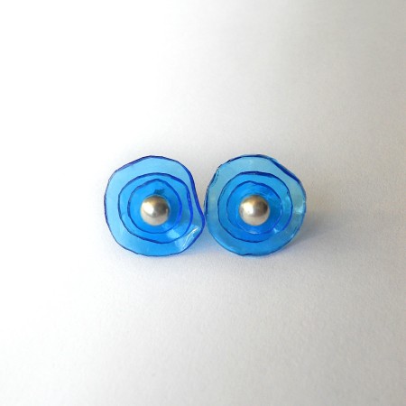 The stud earrings with plastic circles.