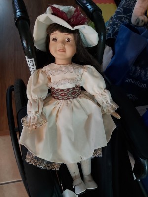A doll in an old fashioned dress.