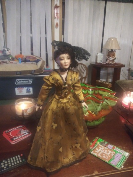 A porcelain doll in an ornate dress.