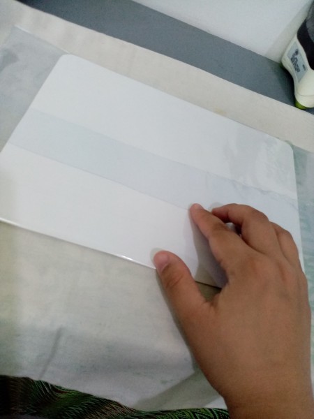 Placing the paper in a plastic sleeve.