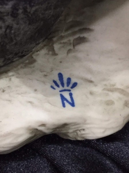 The marking on the bottom of a figurine.