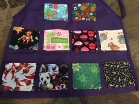 Attaching the patches to the apron as pockets.