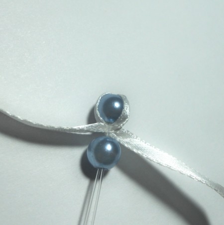 Adding ribbon between each bead.