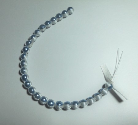 The beaded strand with ribbon.