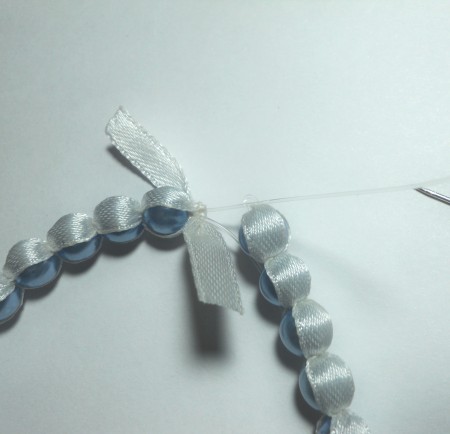 Closing the beaded bangle.