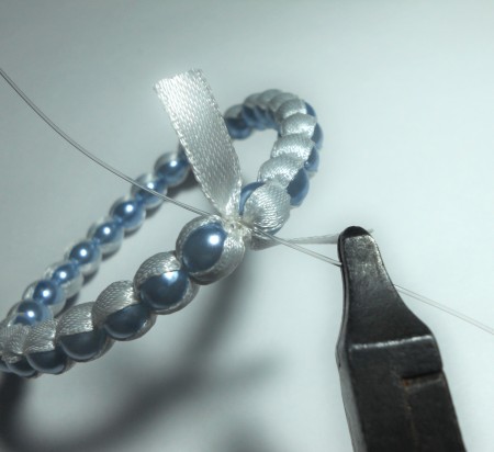 Closing the beaded bangle.