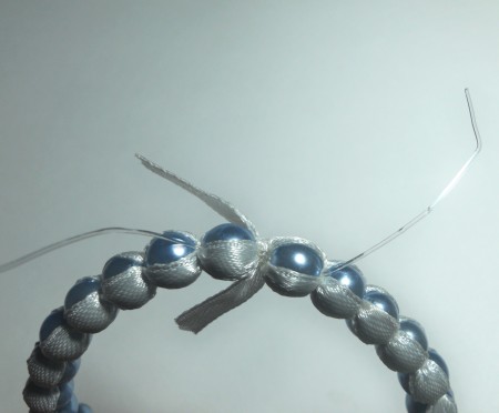 Closing the beaded bangle.