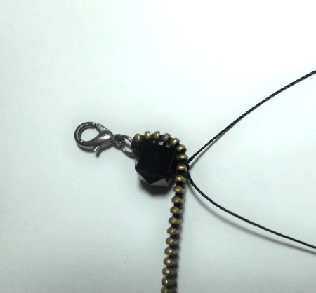 Adding beads to the zipper.