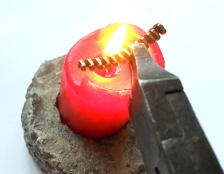 Melting the zipper piece in a flame.