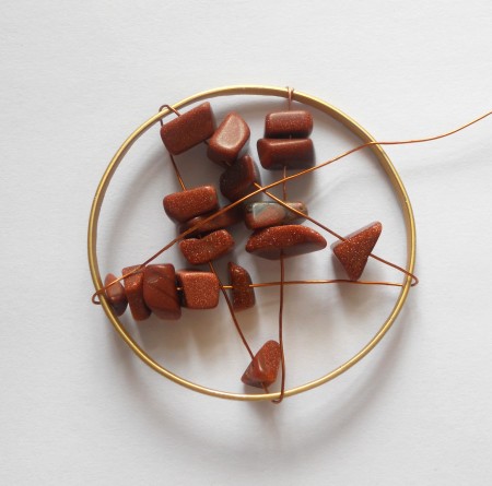 Making a star shape with the beads and wire.