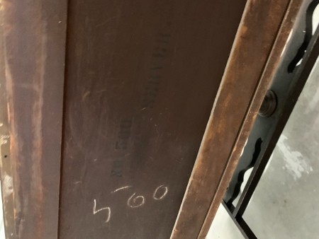 A number written on the back of a piece of furniture.
