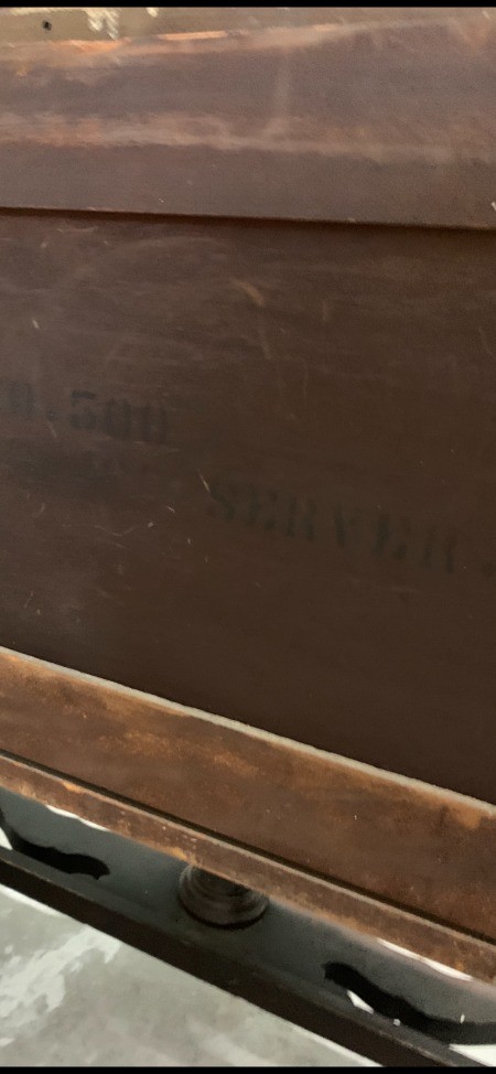 Numbers on the back of a piece of furniture.