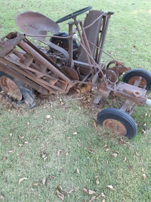 A rusted piece of farm equipment.