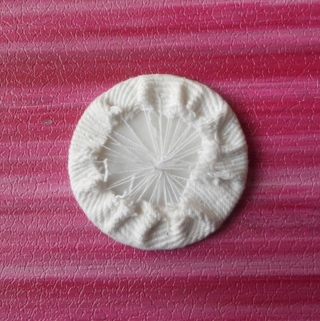 Stitching the denim over the plastic.