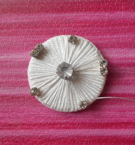 Adding rhinestones to the brooch.