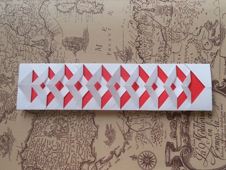 Folding the cuts back to make a three dimensional pattern.