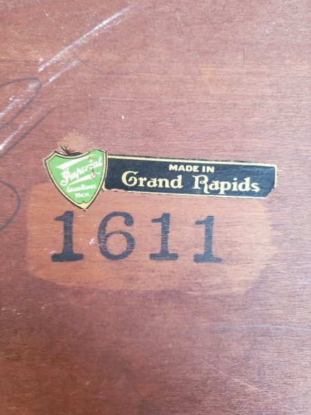 The markings on the bottom of an end table.