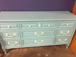 A wooden dresser painted blue.