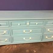 A wooden dresser painted blue.