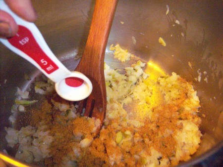 Adding spices to the soup pot.