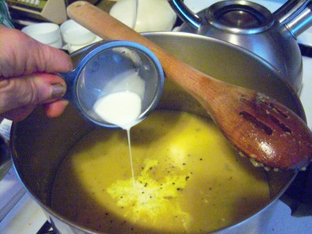 Adding cream to the bisque.