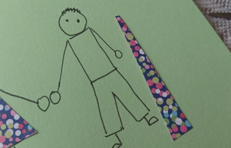 Cutting a tie out of the patterned paper.