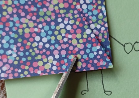 Cutting a triangle out of paper.