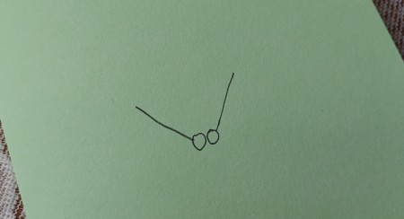 Drawing two hands on a piece of paper.