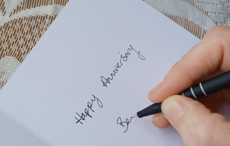 Writing a message in the card.