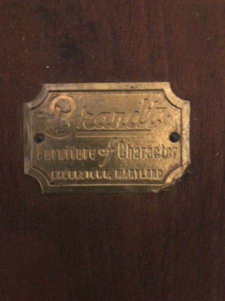 The Brandt logo on the underside of a table.