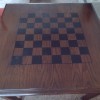 A game table with a checkerboard design on the top.
