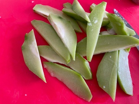 The cut up chayote squash.