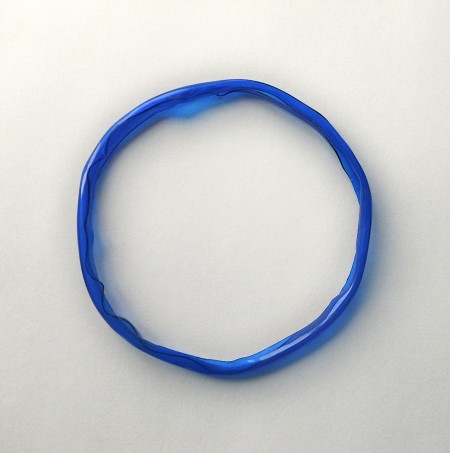 The plastic bangle with a melted edge.