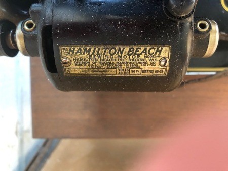The Hamilton Beach manufacturer's plate on a sewing machine.