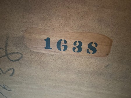 A number on the underside of a desk.