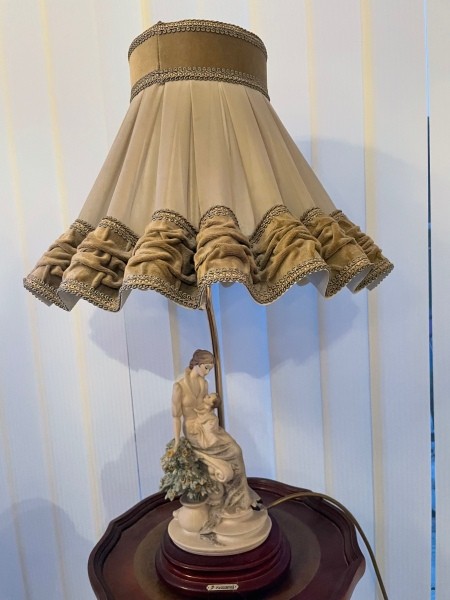 A figurine on a lamp base.