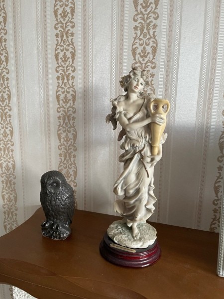 A figurine on a lamp base.