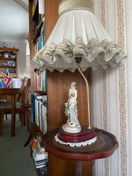 A figurine on a lamp base.