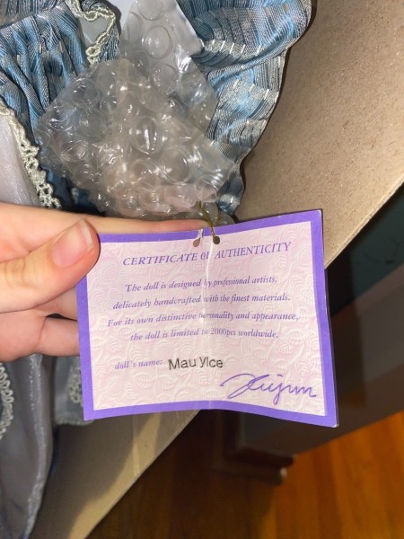The certificate of authenticity on a porcelain doll.